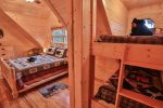 Upstairs queen bed in loft with bunk beds for the kids